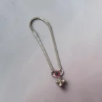 STONIRA-silver-payal-anklet-highlighting-the-pink-enamel-charm-and-three-small-hanging-silver-bells.