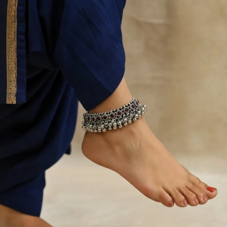 Women-wearing-STONIRA-handcrafted-broad-oxidized-silver-payal-set-with-ruby-red-stones-and-dense-ghungroo-bells.