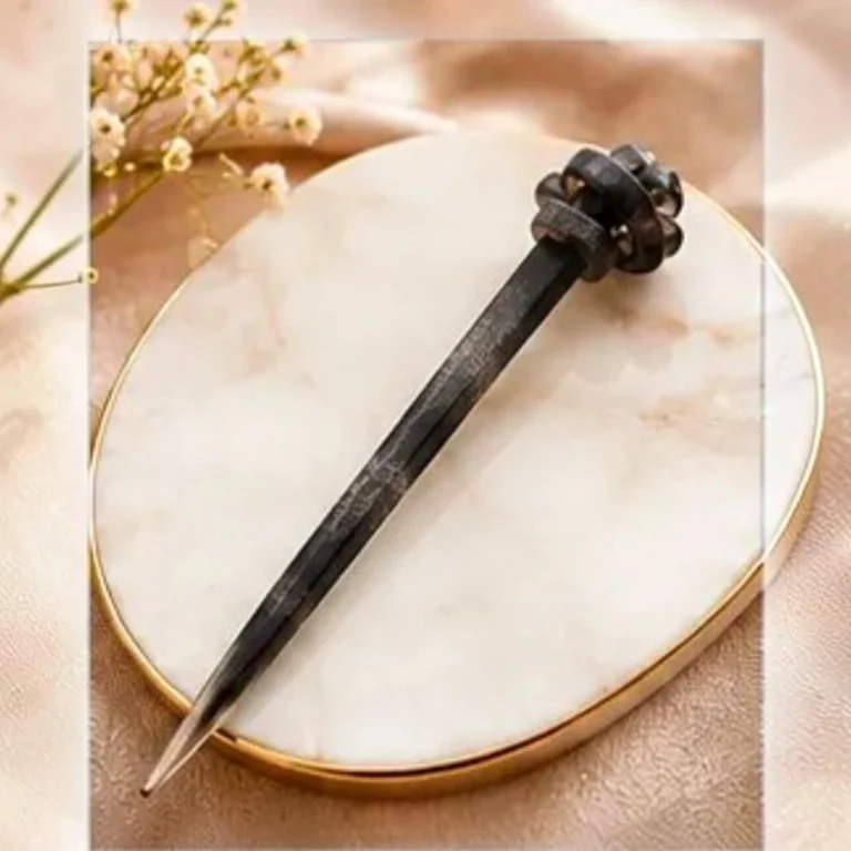 Charcoal grey textured resin hair stick with a sculpted knot accent for buns and updos.