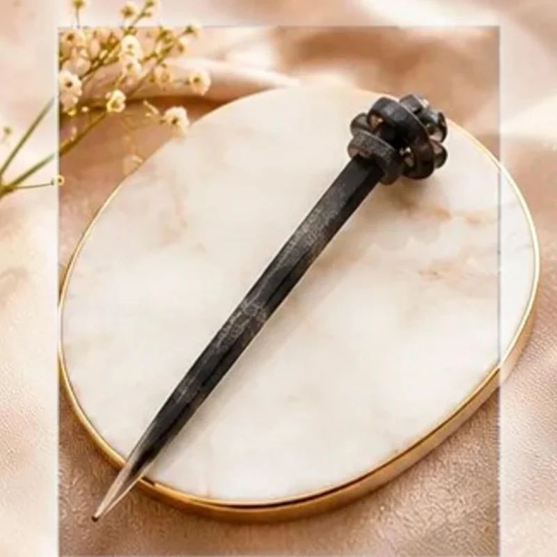 Charcoal grey textured resin hair stick with a sculpted knot accent for buns and updos.