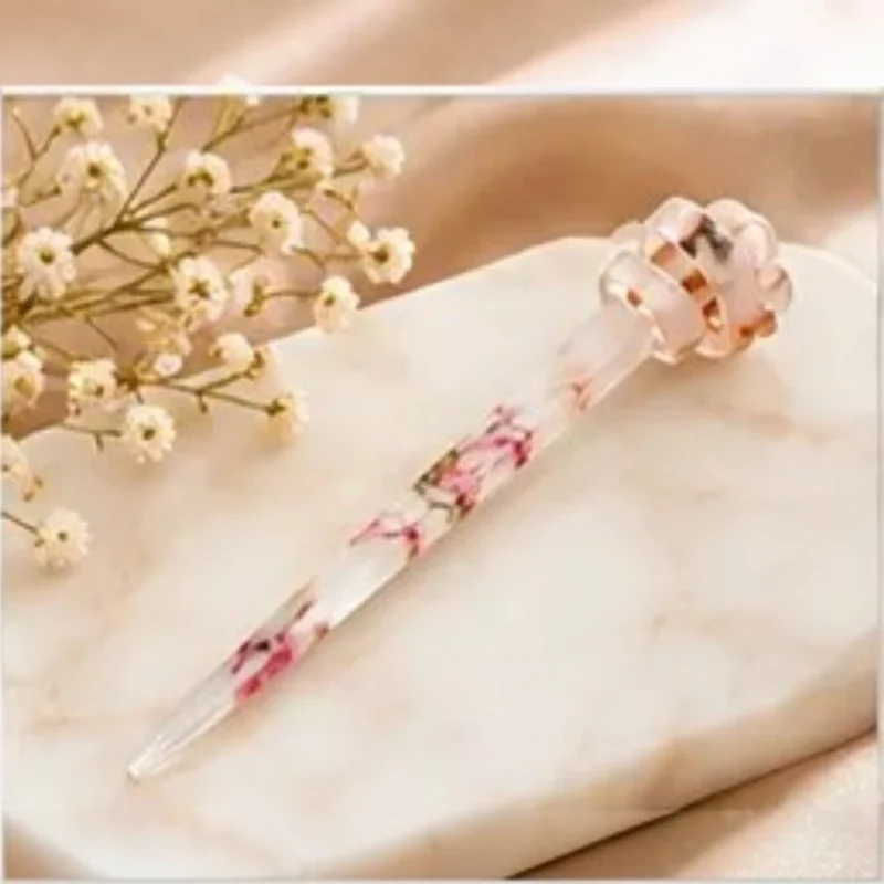 Clear resin hair stick with delicate pink pressed flower inclusions and a sculpted knot accent