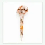 Crystal clear resin hair stick with suspended natural dried botanicals and a sculpted knot detail for buns
