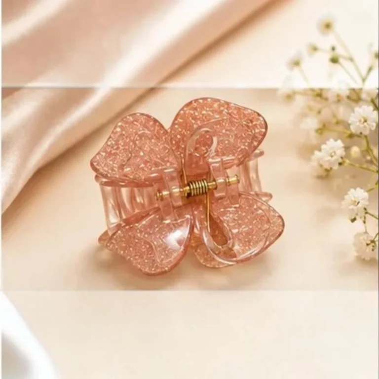 Light peach coral resin butterfly hair claw clip with warm golden shimmer