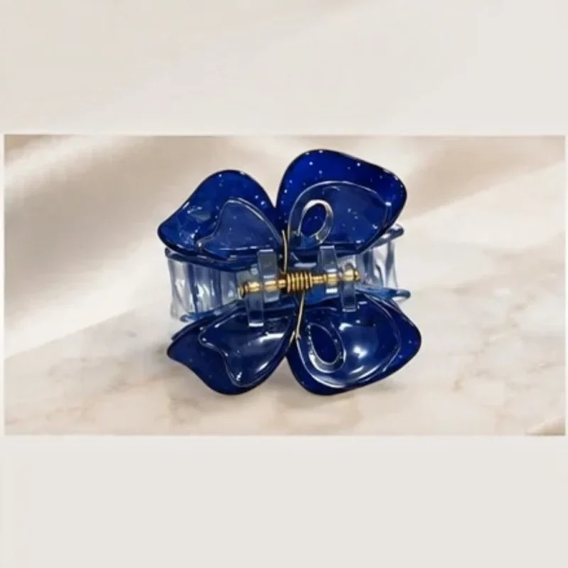 Deep midnight navy blue resin butterfly hair claw clip with a glossy finish.