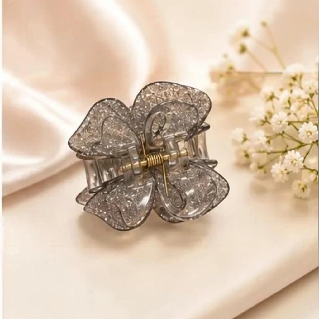Smoky charcoal grey resin butterfly hair claw clip with gold hardware detail Smoky charcoal grey resin butterfly hair claw clip with gold hardware detail.
