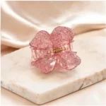 Soft rose quartz pink resin butterfly hair claw clip with delicate glitter flecks.